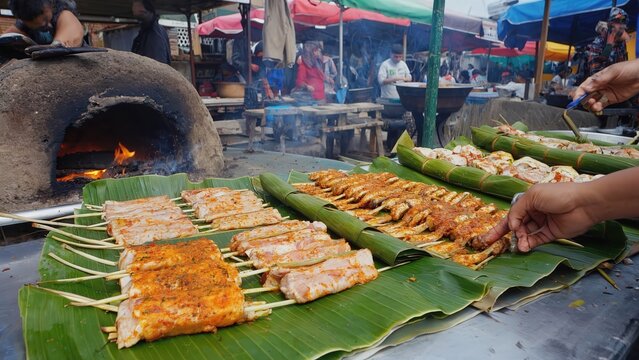 Grilled fish skewers at street market