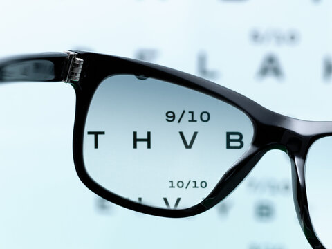 Vision Acuity Test Viewed Through Black Eyeglasses Lens Close Up