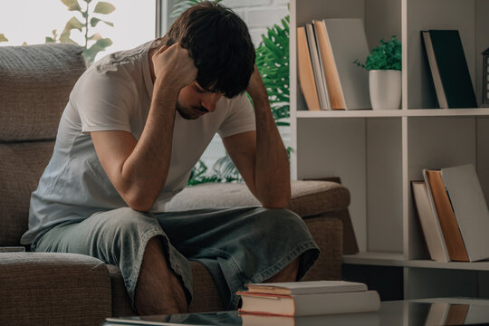 Stressed and frustrated student at home with books