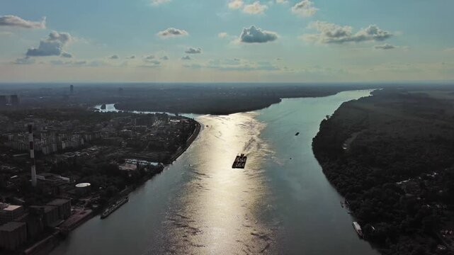 Aerial view of Belgrade at confluence of Sava and Danube rivers. Urban landscape, forested river island and city view, 4k