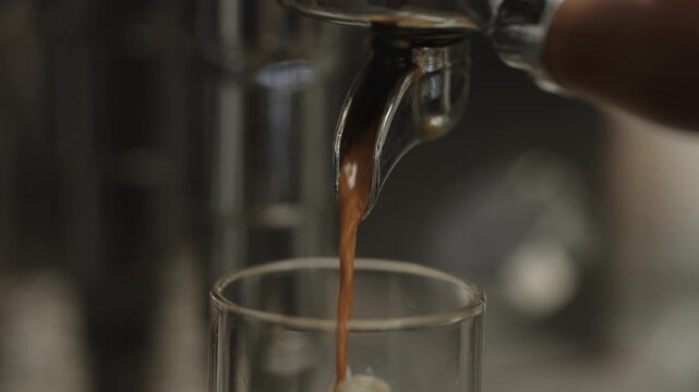 Closeup shot of pulling an espresso shot from coffee machine