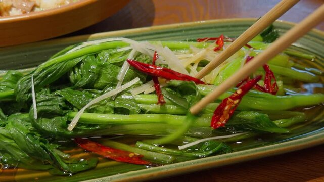 Chopsticks Lifting Oil Drizzled Chinese Choy Sum Vegetables Qingdao Dish