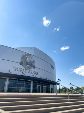 Modern arena exterior under blue sky