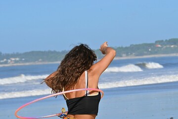 Gymnastics by the ocean  woman with a hoop at A Lanzada Beach, Spain,  October 1, 2026 © GenadiyGM