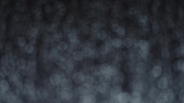 Rain drop hitting window glass and sliding down