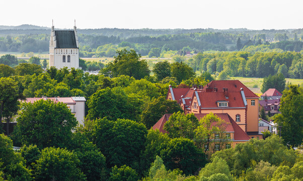 Goldap cityscape with church tower and green trees, Poland
