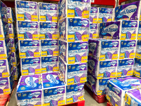 Bath tissue display stacked in club store aisle