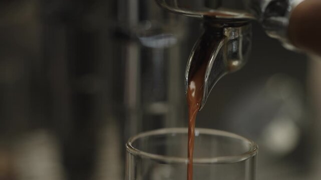 Closeup shot of pulling an espresso shot from coffee machine