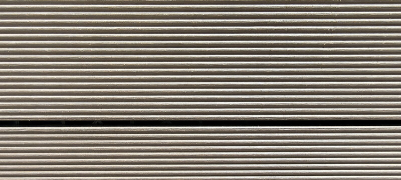 Metallic surface shows parallel ridges and subtle wear