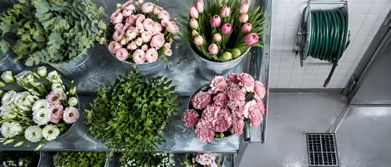 Fototapeta premium Galvanised shelf holding zinc buckets packed with cut blooms in a florist cold room with tiled back wall