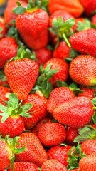 Fresh Ripe Red Strawberries With Green Leaves Filling the Frame © Eva