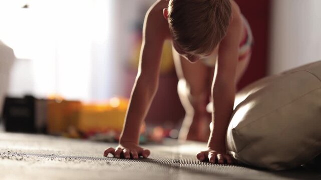 Young boy doing push-ups at home