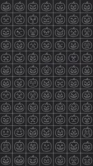 Fototapeta premium Seamless pattern of white outline jack o lantern faces on a dark background.