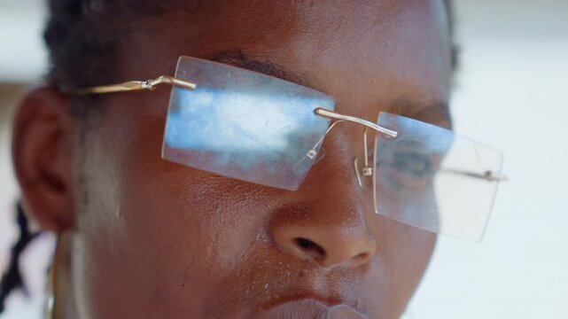 Close up shots focus on details of facial features and eyewear. subject remains in frame throughout with no significant movement or change in camera angle