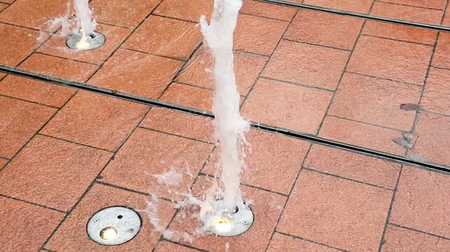 Slow motion water jets from ground fountain