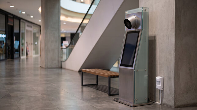 Facial recognition kiosk in modern shopping mall corridor