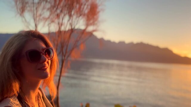 Young Blonde Woman Enjoying Sunset by Lake Geneva in Switzerland