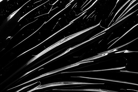 transparent plastic film wrap overlay texture on black background