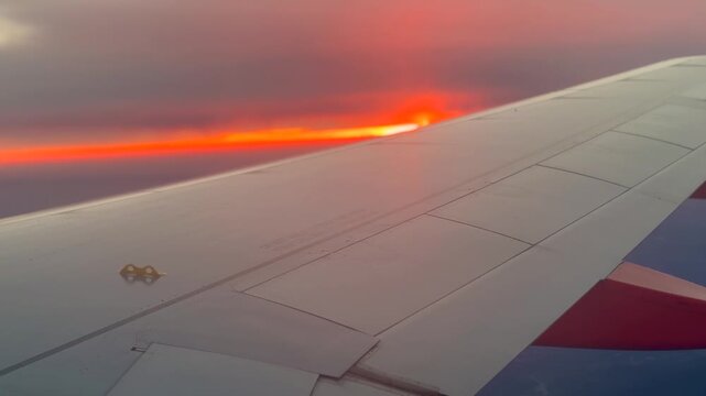 Stunning Sunset Sunflare over Airplane Wing and Clouds from Window Seat