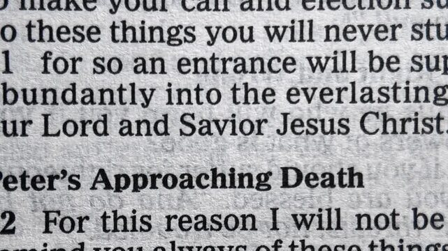 Savior in Bible scripture with slowly changing pages macro close up Christian faith Jesus Christ religious