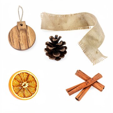 A rustic still life displays a wooden ornament, ribbon, pine cone, orange slice, and cinnamon sticks against a white background.
