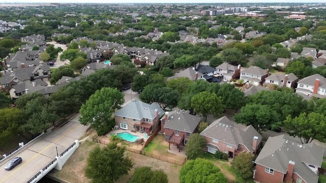 Abundant canopy coverage shades compact residential lots featuring modern suburban dwellings. atmosphere characterizes community streets found throughout Valley Ranch, Valley Ranch, Irving, TX