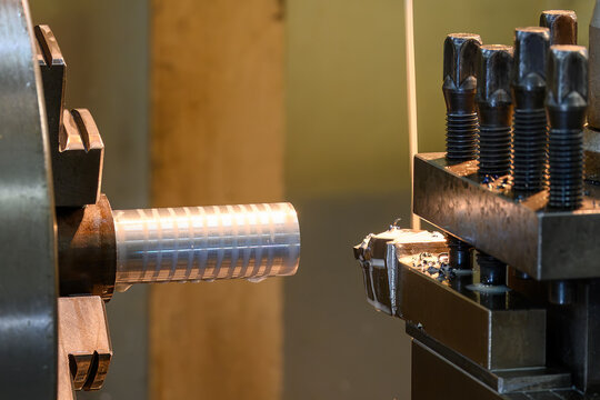  Lathe machine finishing cut on a metal shaft part with liquid coolant in a light blue scene