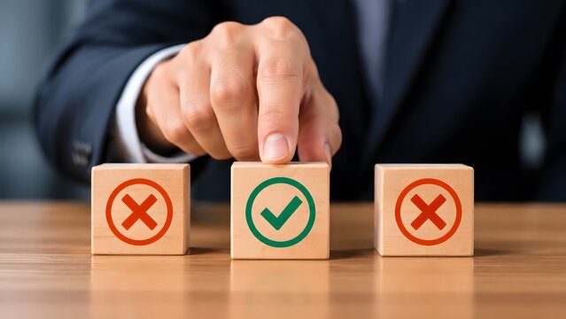 Businessman hand choosing the right path by selecting a wooden block with a green check mark among other blocks with red crosses, representing strategic decision.