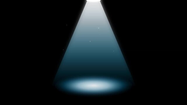 Bright spotlight shining down with glowing dust particles floating gently inside dark theatrical stage video clip