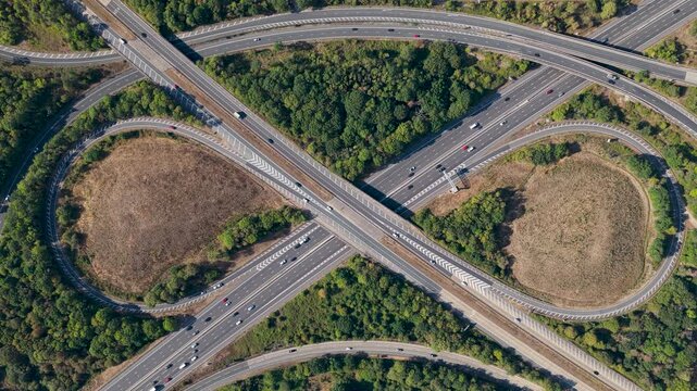 Aerial View of Highway Interchange With Moving Cars