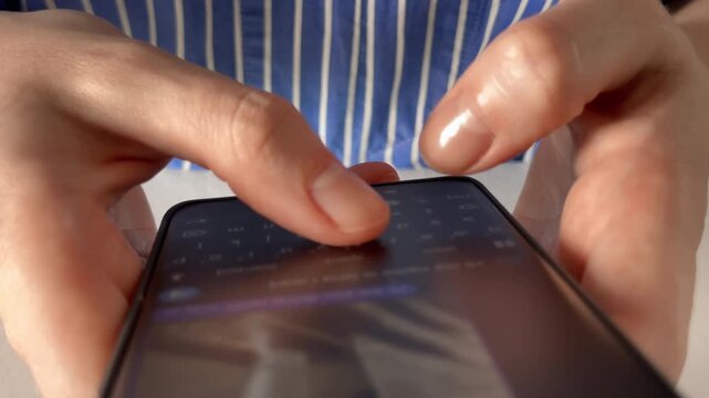 Thumb fast typing online messages on a mobile phone screen close up view. Person chatting in a messenger application for instant communication and distant social conversation. Female hands