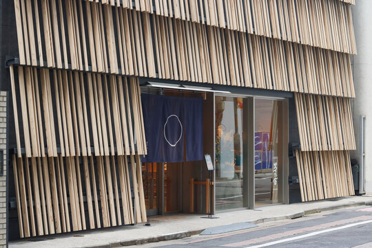 TOKYO, JAPAN - September 27, 2026: Detail of the front of Kayanoya Ginza, a shop specializing in dashi. The building was designed by Kengo Kuma.