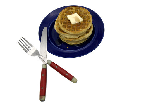 waffles with butter and syrup on a blue plate with red handled fork and knife Isolated on transparent background&nbsp;