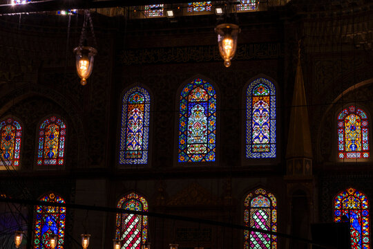 Stained glass windows and lanterns inside historic mosque