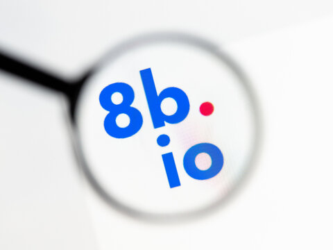 Milan, Italy 2026, 15 AGO Closeup of 8b io website page on a laptop screen. Focus on 8b io logo under a magnifying glass.