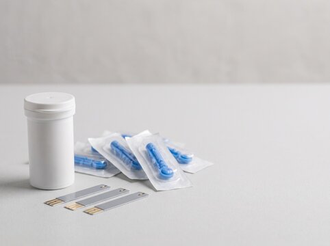 White diabetes medication pills and bottle on neutral background for awareness campaigns