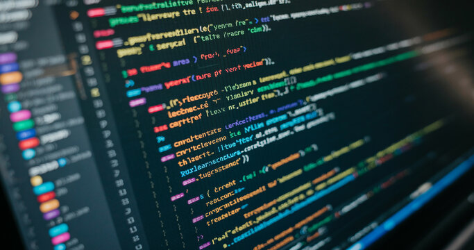 Computer code displayed on a dark monitor screen for software