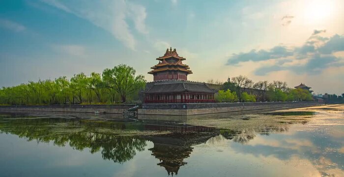 Forbidden City corner tower reflected in moat at golden hour, Beijing historic palace complex