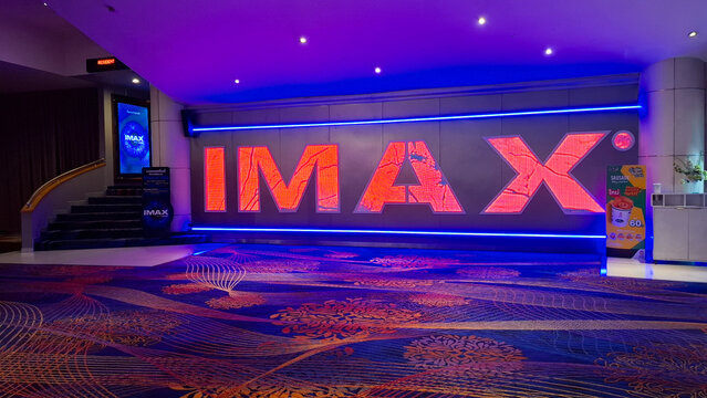 Illuminated imax theater entrance logo signage and carpeted lobby with purple blue ambient lighting on September 28, 2026 in Bangkok, Thailand 
