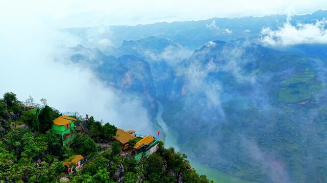 Ascending aerial orbit around a ridge-top cafe revealing the Nho Que River and surrounding gorges