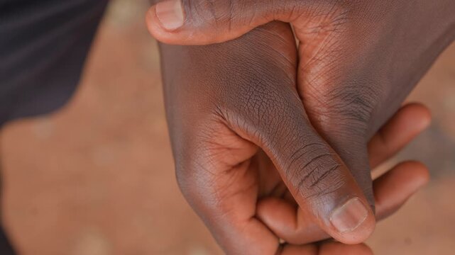 Close up view of hands with detailed skin texture showing fingers and thumb in various positions. No separate objects or equipment visible focus remains on hand details throughout