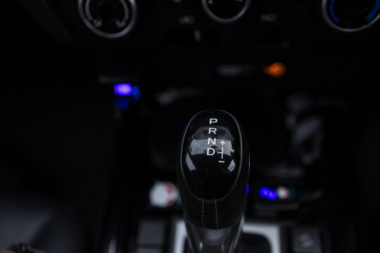 Close-up of modern car automatic gear shift knob with PRND markings,A detailed close-up shot of a modern car's automatic gear shift knob, featuring the clearly marked positions for Park, Reverse,