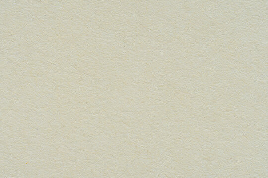 Macro Close-Up Texture of Light Beige Recycled Paper Sheet,Macro close-up texture of a light beige recycled paper background showing subtle natural organic fibers, perfect for design, backdrop,