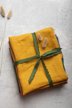 Stacked Linen Fabric Remnants Tied with Fringed Ribbon