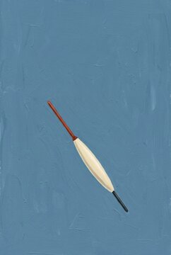 Red and cream fishing float on a blue background