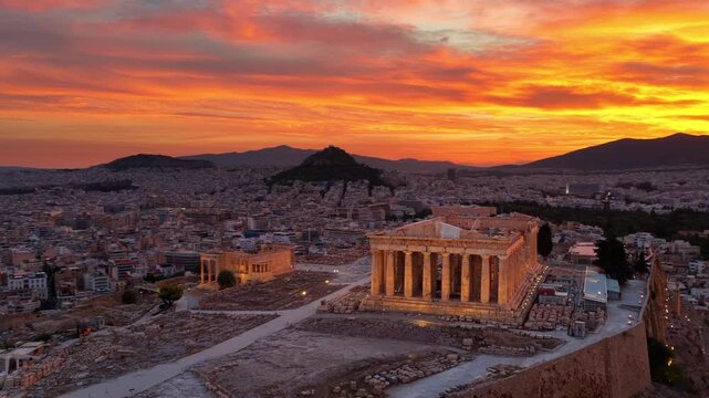 Morning aerial view of Athens with Parthenon temple on the Acropolis hill and city skyline of Greek capital, dramatic sunrise in Athens drone view
