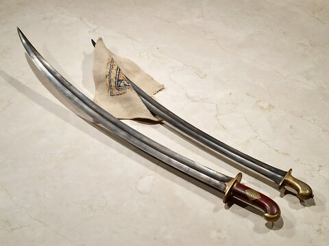Two traditional ottoman kilij swords with curved blades and ornate handles
