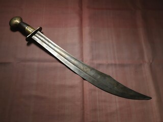 Fototapeta premium Antique falchion sword with brass hilt and wooden handle