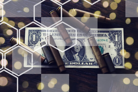 Live ammunition with bullets,  bills, close-up, selective focusing. Concept: sale of weapons under lend-lease, assistance with weapons, mercenaries in the army, trade in ammunition.