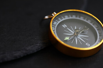 Vintage Brass Compass on Dark Slate Background: Timeless Navigation and Adventure Theme © alexkich